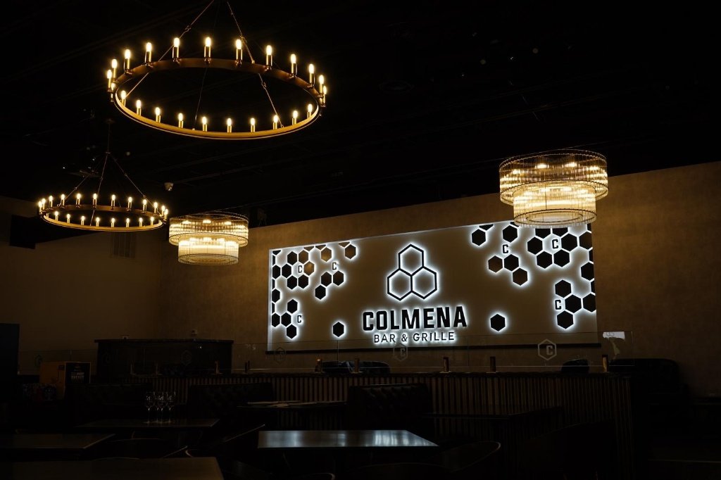 Main interior with honeycomb logo wall and chandeliers